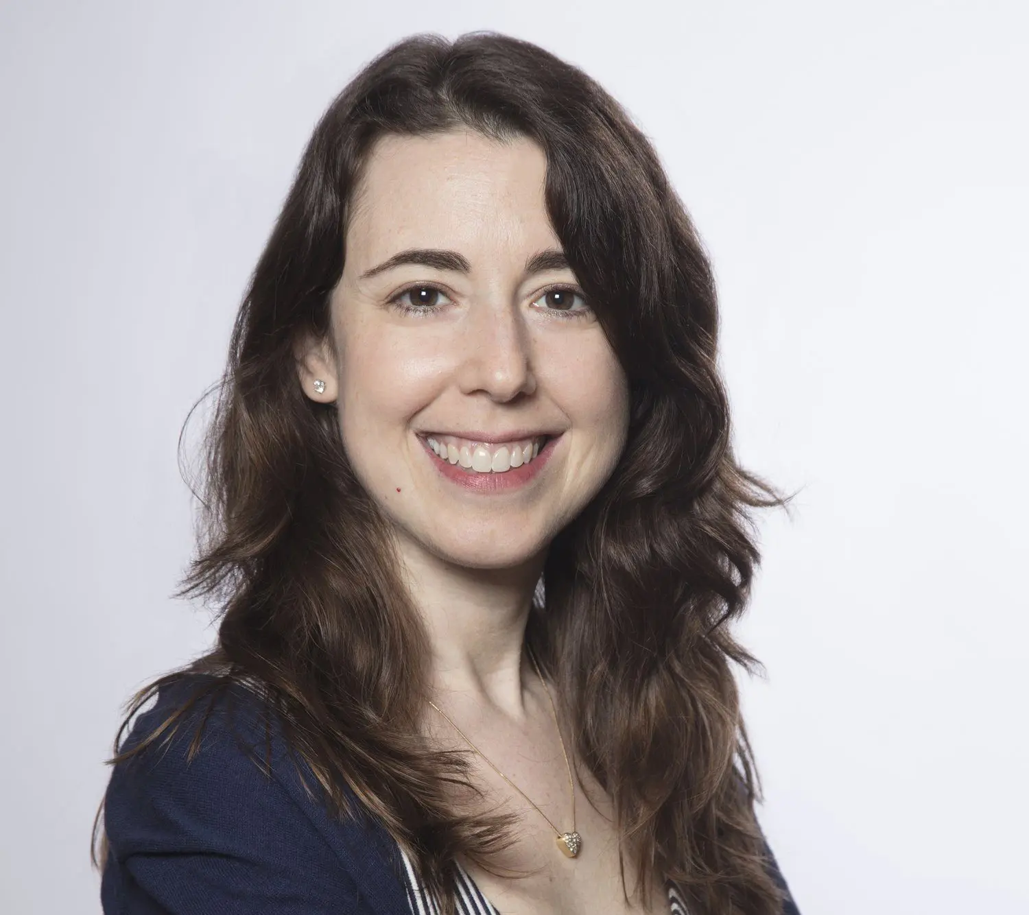 Amanda Feinstein smiles in a navy blue cardigan
