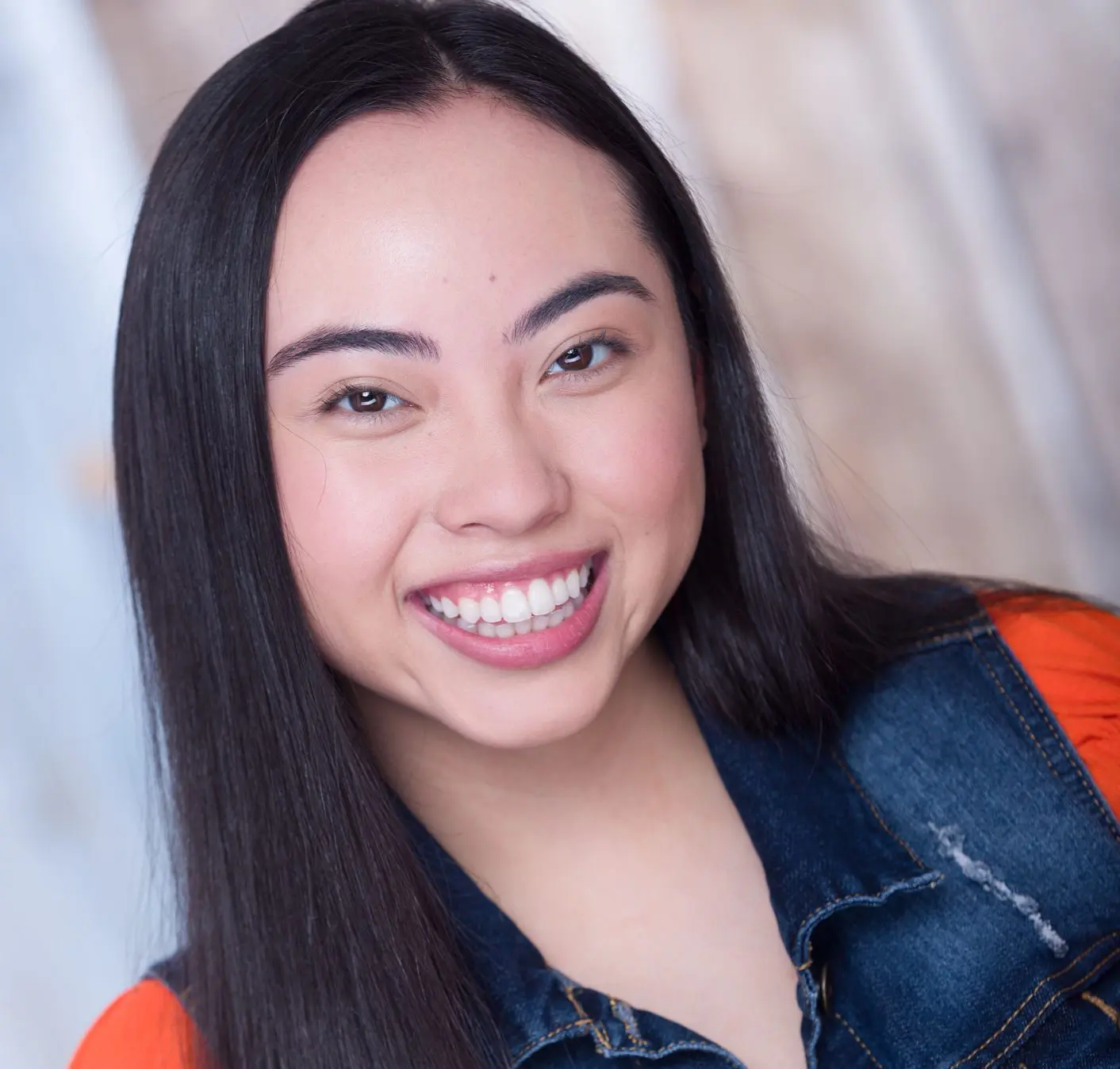 Aaliyah Magcasi smiles in a jean vest