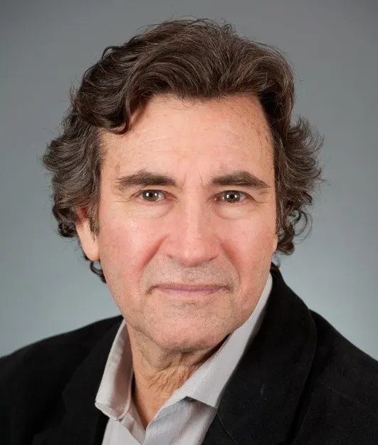 Neil Schechter wears a black suit