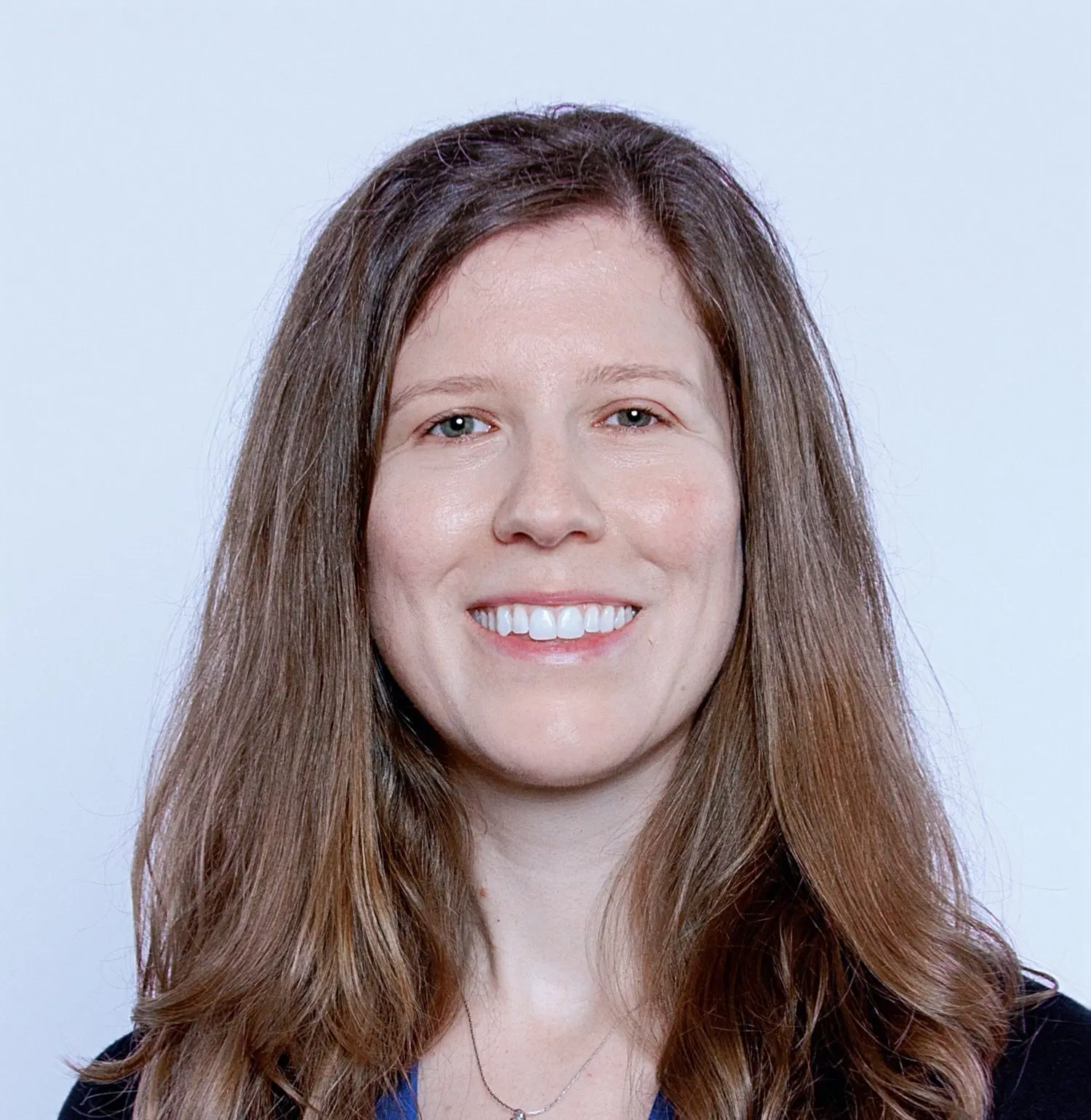 Stephanie Punt smiles in a blue shirt with a necklace