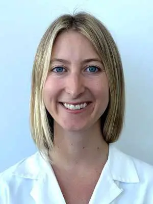 Sara Ptasnik smiles in a white shirt